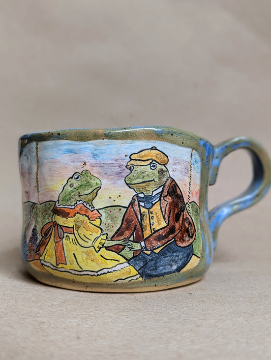 Handmade ceramic mug with frogs in love