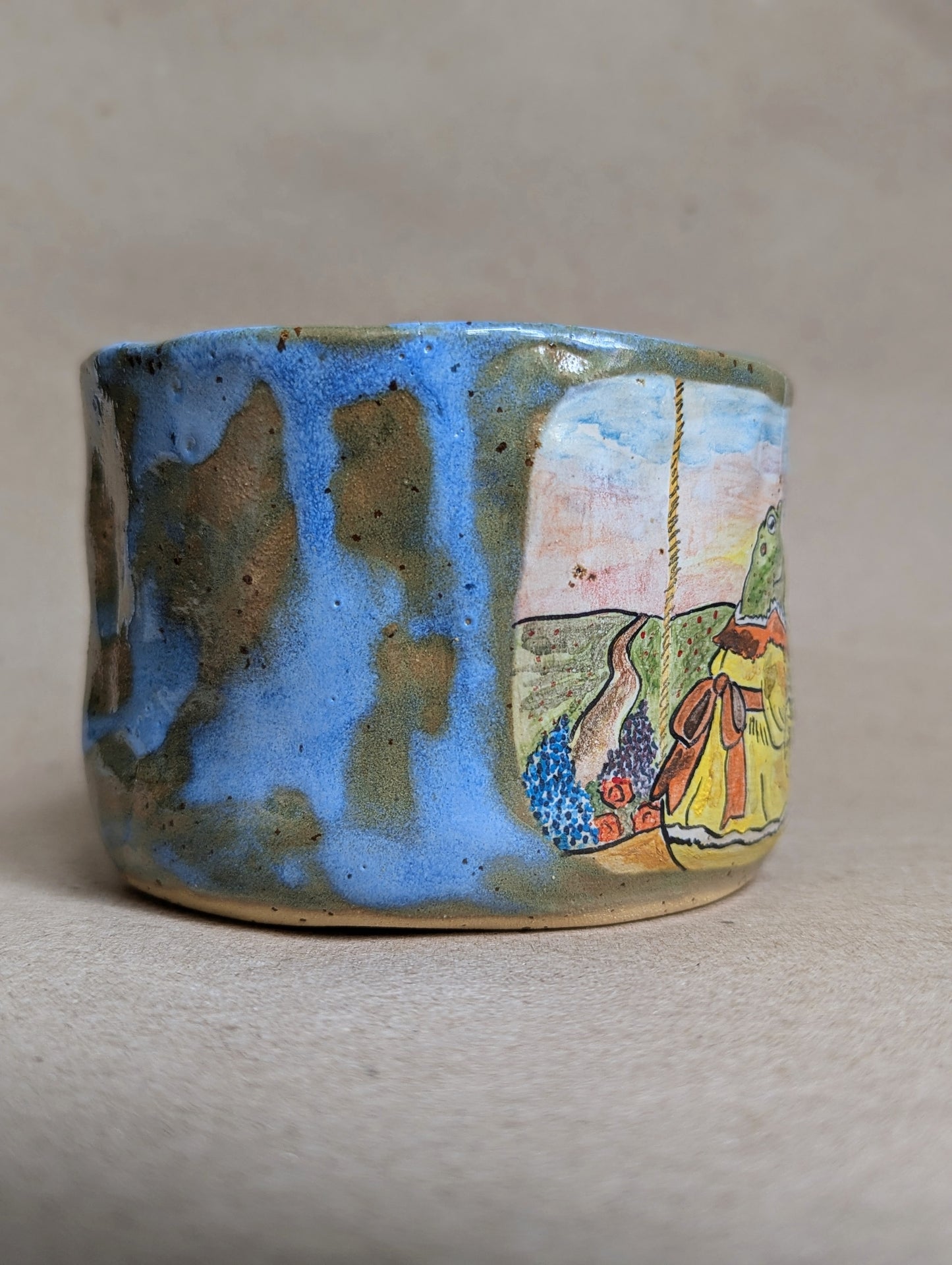 Handmade ceramic mug with frogs in love