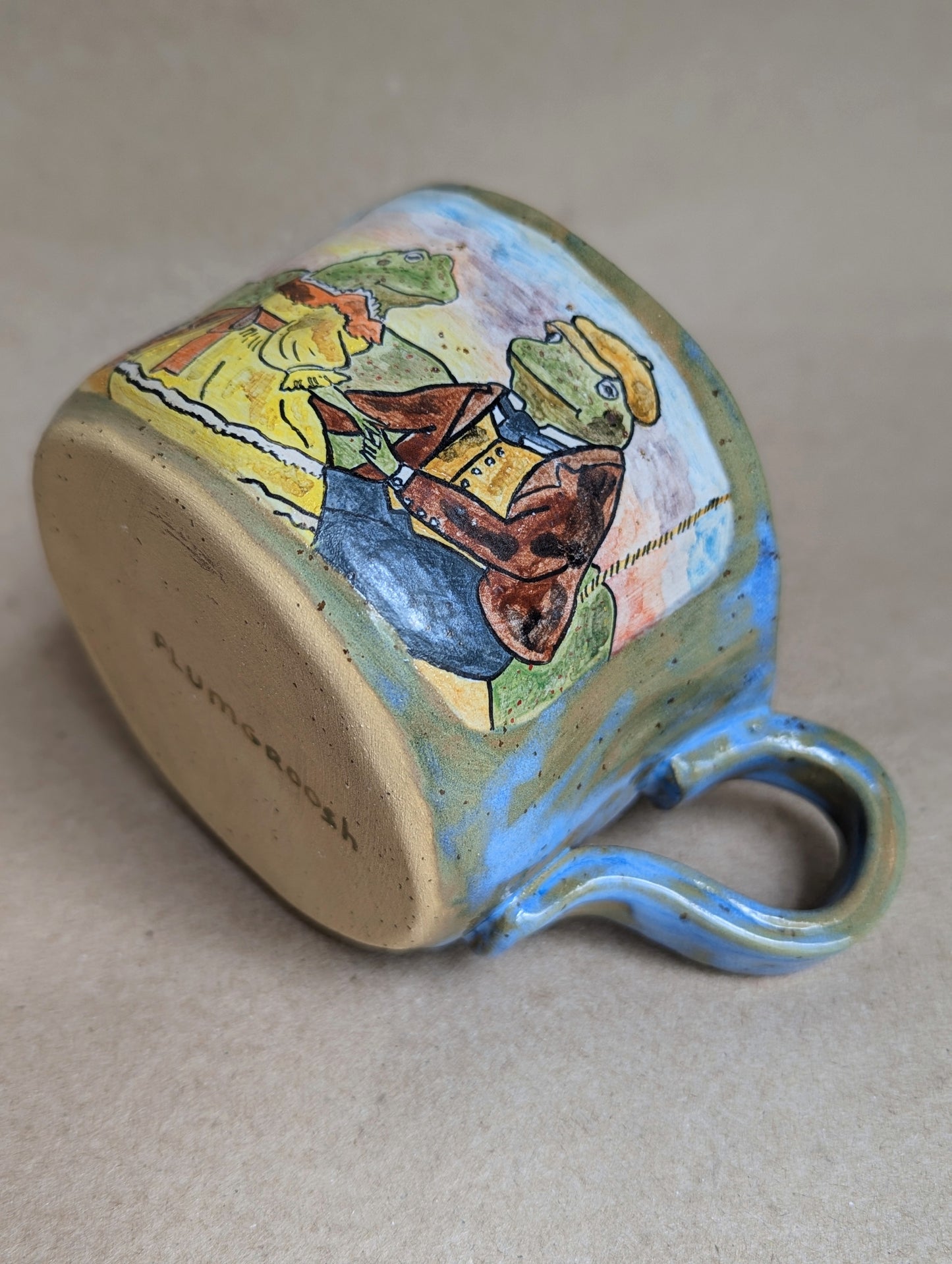 Handmade ceramic mug with frogs in love